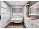 Bright bathroom featuring a freestanding tub, modern vanity, and separate shower with glass door at 1657 Bayshore Dr, Englewood, FL 34223