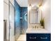 Nicely appointed bathroom with blue tile shower, modern vanity and mirror at 1657 Bayshore Dr, Englewood, FL 34223