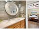 Bathroom with decorative wood walls, white granite counter, sink and decorative mirror at 1657 Bayshore Dr, Englewood, FL 34223