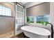 Bright bathroom featuring a freestanding tub, modern vanity, and separate shower with glass door at 1657 Bayshore Dr, Englewood, FL 34223