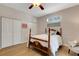 Bedroom with hardwood floors, ceiling fan, double closets and a coastal style art piece at 1657 Bayshore Dr, Englewood, FL 34223