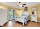 Bright bedroom boasts balcony access, hardwood floors, ceiling fan, and coastal accents at 1657 Bayshore Dr, Englewood, FL 34223
