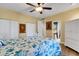 Bedroom features ceiling fan, hard wood floors and en-suite bathroom access at 1657 Bayshore Dr, Englewood, FL 34223