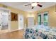 Cozy bedroom boasts balcony access, hardwood floors, ceiling fan, and bathroom access at 1657 Bayshore Dr, Englewood, FL 34223