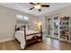 Bedroom with hardwood floors, desk and a balcony with shuttered doors at 1657 Bayshore Dr, Englewood, FL 34223