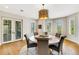 Elegant dining room with a round table, chandelier, and natural light at 1657 Bayshore Dr, Englewood, FL 34223