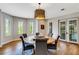 Inviting dining room with a round table, stylish chandelier, and French doors at 1657 Bayshore Dr, Englewood, FL 34223