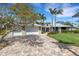 Front exterior view of the property, featuring a three car garage and a circular turret entry at 1657 Bayshore Dr, Englewood, FL 34223