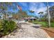 Charming home exterior with a well-manicured front yard and long driveway at 1657 Bayshore Dr, Englewood, FL 34223