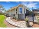 Rear exterior view with stone walkway leading to the fenced pool area at 1657 Bayshore Dr, Englewood, FL 34223