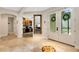 Inviting foyer with double doors, views of the office, kitchen, and a decorative compass mosaic inset in the tile floor at 1657 Bayshore Dr, Englewood, FL 34223