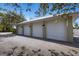 Spacious four-car garage with three visible bay doors at 1657 Bayshore Dr, Englewood, FL 34223