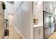 Spacious hallway with elegant decor, leading to kitchen with stainless steel fridge at 1657 Bayshore Dr, Englewood, FL 34223