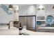 Well-lit kitchen featuring stainless steel appliances and an island with a wine display at 1657 Bayshore Dr, Englewood, FL 34223