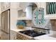 Close-up showcasing stainless steel appliances and custom tile backsplash in a beautifully designed kitchen at 1657 Bayshore Dr, Englewood, FL 34223