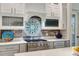 Gourmet kitchen with stainless steel appliances, quartz counters, and custom cabinetry at 1657 Bayshore Dr, Englewood, FL 34223