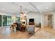 Cozy living room with a fireplace, wood floors, and plenty of natural light at 1657 Bayshore Dr, Englewood, FL 34223