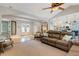 Spacious living area with a leather sofa that opens to dining room and kitchen at 1657 Bayshore Dr, Englewood, FL 34223