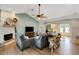 Inviting living area with a stone fireplace, wood floors, and an open layout leading to the entryway at 1657 Bayshore Dr, Englewood, FL 34223