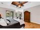Bedroom featuring wood floors, a tray ceiling, access to a workout room, and a balcony at 1657 Bayshore Dr, Englewood, FL 34223