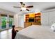 Bright main bedroom with hardwood floors, ceiling fan, and built-in storage at 1657 Bayshore Dr, Englewood, FL 34223