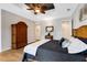 Spacious bedroom with wood floors, a tray ceiling, and a large armoire for storage at 1657 Bayshore Dr, Englewood, FL 34223