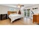 Bright main bedroom with hardwood floors, ceiling fan, and balcony access at 1657 Bayshore Dr, Englewood, FL 34223