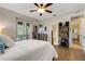 Bright main bedroom featuring a ceiling fan, french doors, and shelving perfect for a curated collection at 1657 Bayshore Dr, Englewood, FL 34223