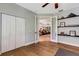 Bright room with door leading to the living room, built-in shelving, and lots of storage at 1657 Bayshore Dr, Englewood, FL 34223