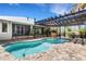 Stunning pool with covered seating, tiki bar, and lush landscaping at 1657 Bayshore Dr, Englewood, FL 34223