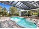 Relaxing pool area features a covered patio, integrated spa, and a beautifully paved deck, perfect for outdoor enjoyment at 1657 Bayshore Dr, Englewood, FL 34223