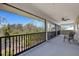 Screened porch with black railings and beautiful forest views at 1657 Bayshore Dr, Englewood, FL 34223