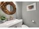 Charming powder room with modern vanity, decorative mirror, and stylish accents at 1657 Bayshore Dr, Englewood, FL 34223