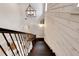 Aerial view of staircase with custom light fixture and a decorative accent wall at 1657 Bayshore Dr, Englewood, FL 34223
