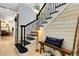 Staircase showcasing classic black and white design with plank siding and a decorative bench at 1657 Bayshore Dr, Englewood, FL 34223