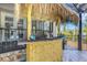 Charming tiki bar offers the perfect spot for outdoor entertaining and poolside refreshments at 1657 Bayshore Dr, Englewood, FL 34223