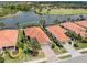 An aerial view of a home in a beautiful neighborhood featuring lake access and well-maintained landscaping at 177 Treviso Ct, North Venice, FL 34275