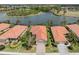 An aerial view of a neighborhood featuring single-Gathering homes, lake access, and lush green landscaping at 177 Treviso Ct, North Venice, FL 34275