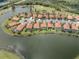 An aerial view of a home in a gated community, located on a lake near a golf course at 177 Treviso Ct, North Venice, FL 34275