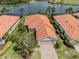 Beautiful single-story home with a red tile roof overlooking a scenic lake and golf course in a desirable community at 177 Treviso Ct, North Venice, FL 34275
