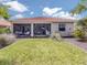 Manicured backyard with a view of a screened lanai, lush lawn and landscaping at 177 Treviso Ct, North Venice, FL 34275
