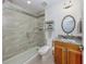Modern bathroom featuring a glass enclosed shower, a wood vanity, and stylish fixtures at 177 Treviso Ct, North Venice, FL 34275