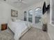 Bright bedroom featuring a ceiling fan, plush carpet, and three windows at 177 Treviso Ct, North Venice, FL 34275