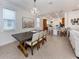 Open concept dining room with chandelier and access to the kitchen, creating a perfect space for gathering and entertaining at 177 Treviso Ct, North Venice, FL 34275