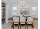 Chandelier highlights dining room with a view through large glass doors at 177 Treviso Ct, North Venice, FL 34275
