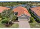 Beautiful single-Gathering home featuring a tile roof, attached two-car garage, and a paver driveway and walkway at 177 Treviso Ct, North Venice, FL 34275