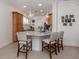 Kitchen area with granite countertops, wood cabinets, and barstool seating at 177 Treviso Ct, North Venice, FL 34275