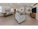 Open-concept living space featuring tile flooring, recessed lighting, and seamless flow to the dining and kitchen areas at 177 Treviso Ct, North Venice, FL 34275