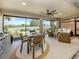 Outdoor living space including dining and lounging with serene water view at 177 Treviso Ct, North Venice, FL 34275