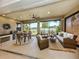 Serene outdoor living space with a dining area, grill, and comfortable seating overlooking a tranquil lake at 177 Treviso Ct, North Venice, FL 34275